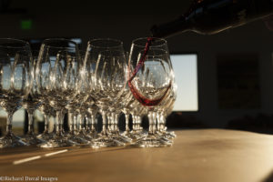 Red wine pouring into glasses