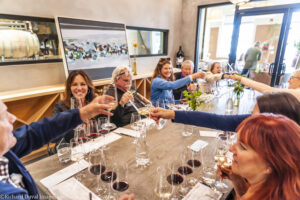 Table of wine drinkers cheersing at the Walls